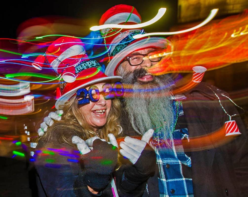 Trip, left, and Jess Barrios walk the Strip on Tuesday, Dec. 31, 2019, in Las Vegas. (Benjamin ...