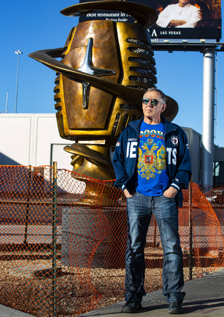 Artist Wayne Littlejohn poses with his sculpture, "Spin Baby," at the intersection of ...