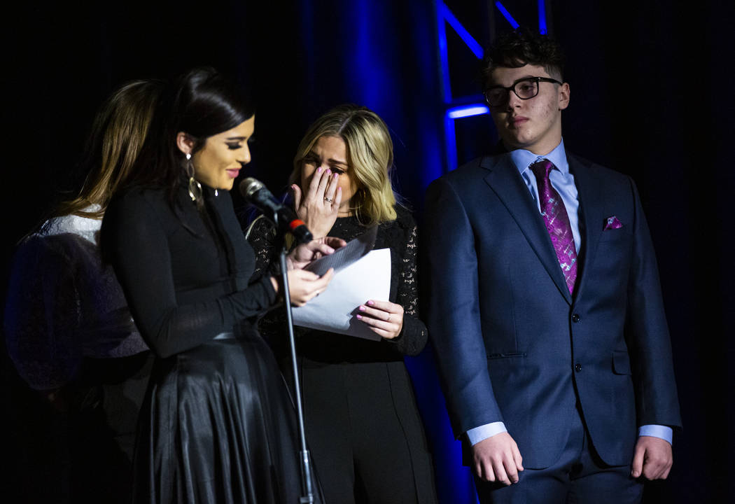 Thalia Trentacarlini, center, and brother, Gabriel, right, react as sister, Isabella, talks abo ...
