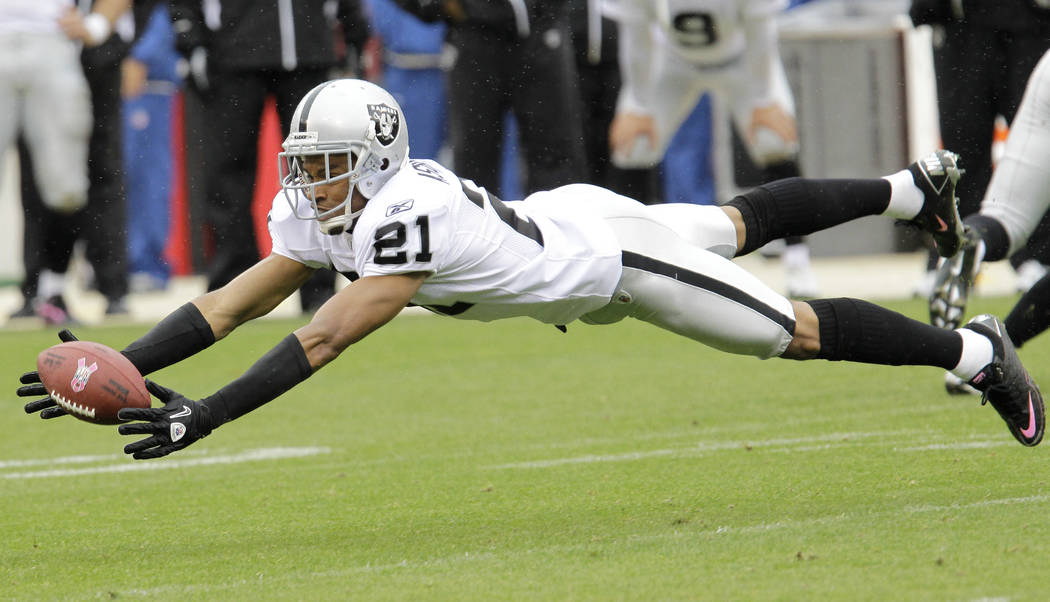 Oakland Raiders cornerback Nnamdi Asomugha (21) tries to intercept a pass, which he did not, ag ...