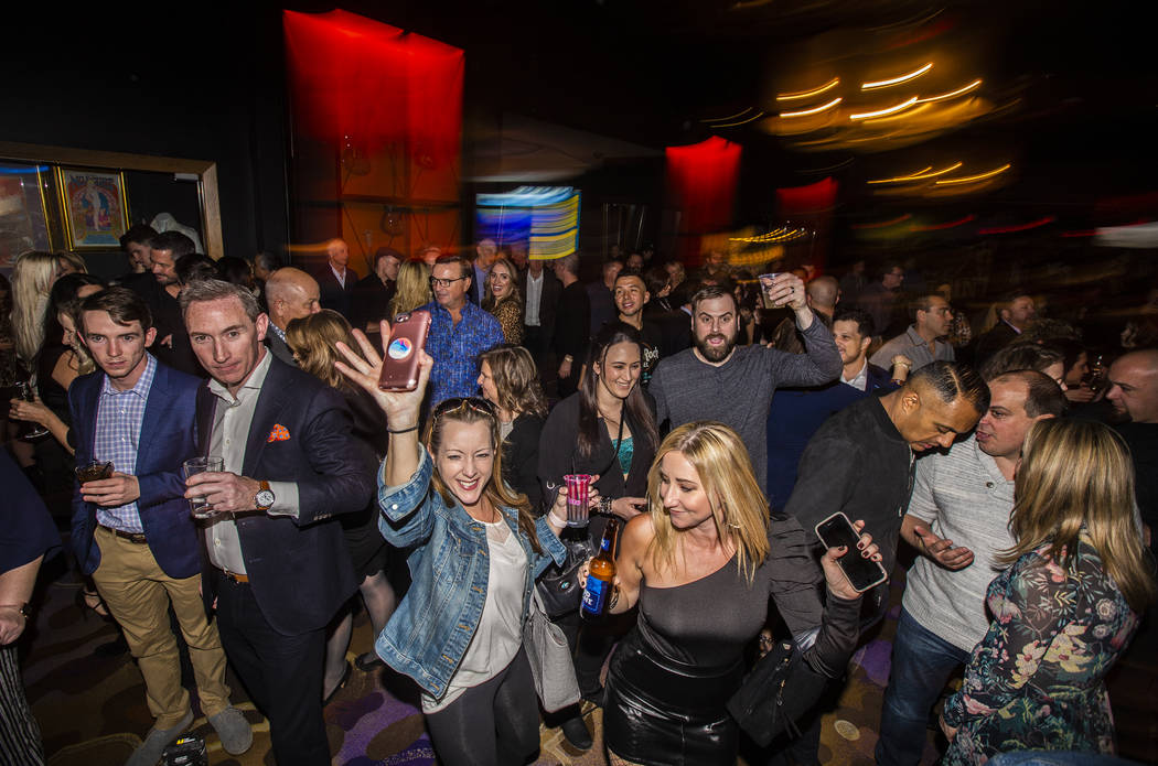 A large crowd gathers to listen to the All Request Live band during an event to say goodbye to ...