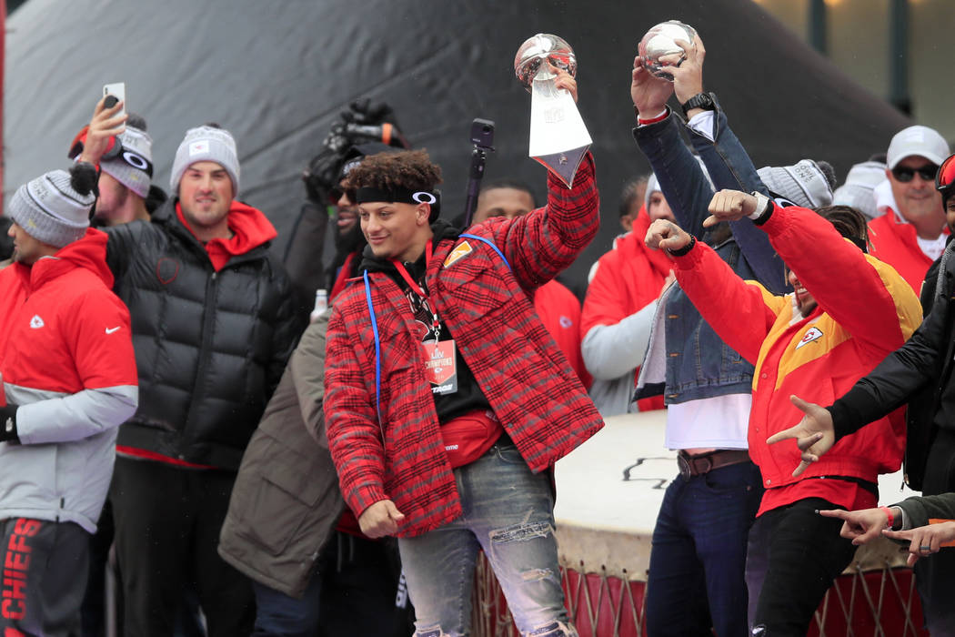 Kansas City Chiefs quarterback Patrick Mahomes holds the Super Bowl trophy during a rally in Ka ...