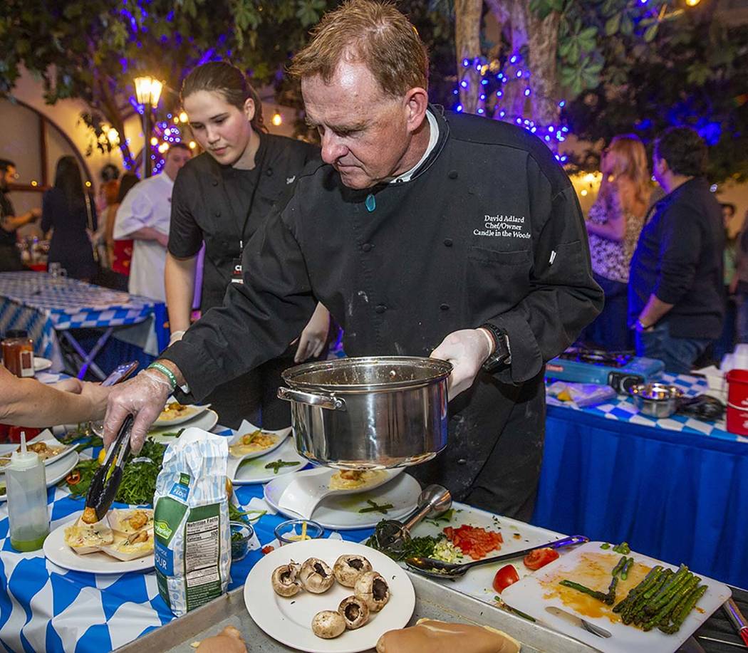 Chef David Adlard, Chef Battle Spokane winner, plates his ravioli and seared chicken dish as ti ...
