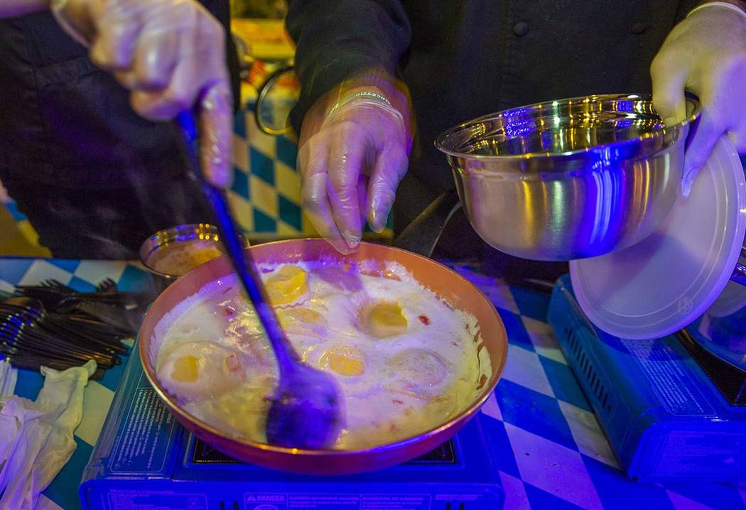 Chef David Adlard, Chef Battle Spokane winner, prepares his ravioli and seared chicken dish as ...