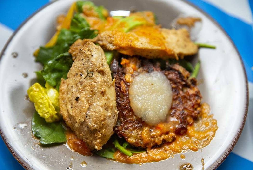 A chicken breast with roasted bell pepper salad and latke dish by Chef Ariella Katzberg, Chef B ...