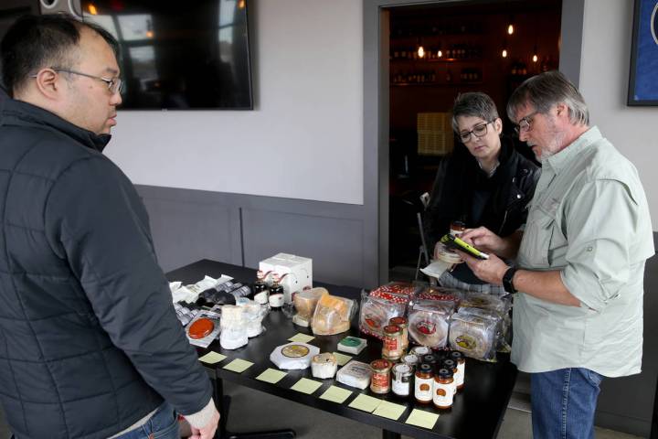 Michael Stamm, owner of MGP Specialty Food, right, and cheese consultant Carolene Belasco sell ...