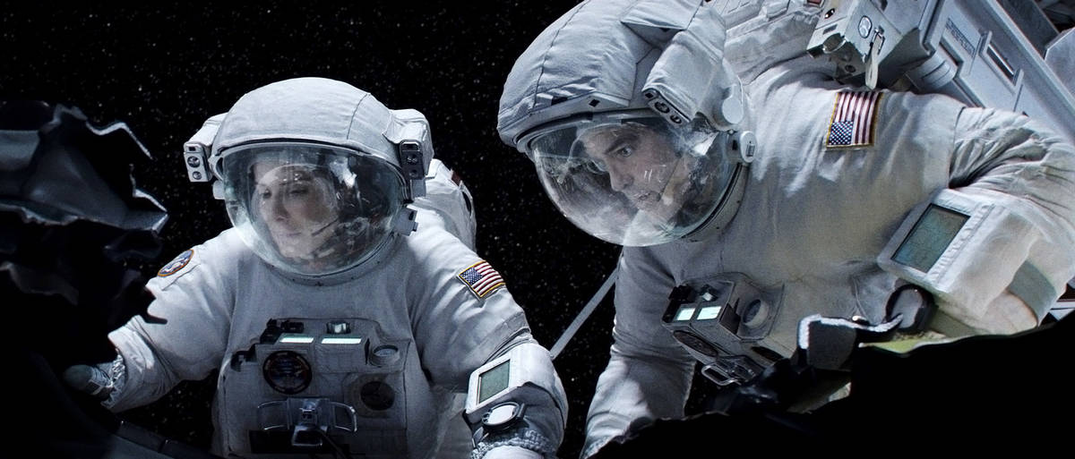 Sandra Bullock as Ryan Stone and George Clooney as Matt Kowalski star in Warner Bros. Pictures& ...