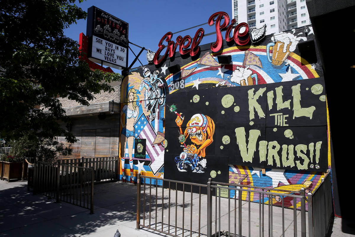 A mural by artists Jeff Lewis and Dustin Hoots on the boarded up windows of Evel Pie on East Fr ...