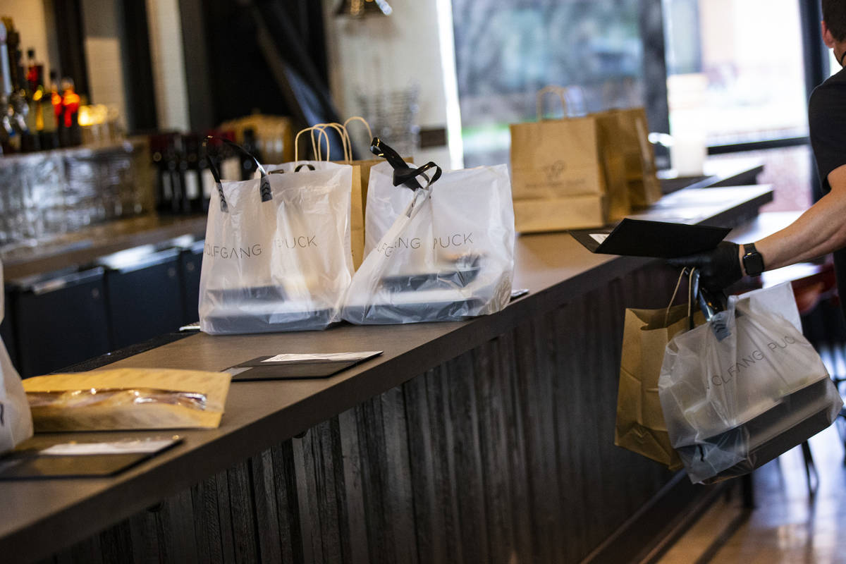 Takeout orders are prepared at Wolfgang Puck Players Locker in Downtown Summerlin in Las Vegas ...