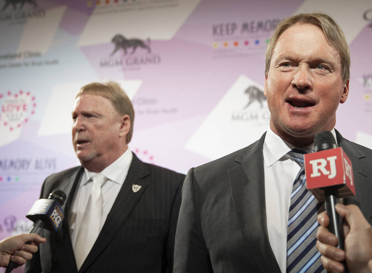 Raiders head coach Jon Gruden, right, and Raiders owner Mark Davis talk with the media on the r ...