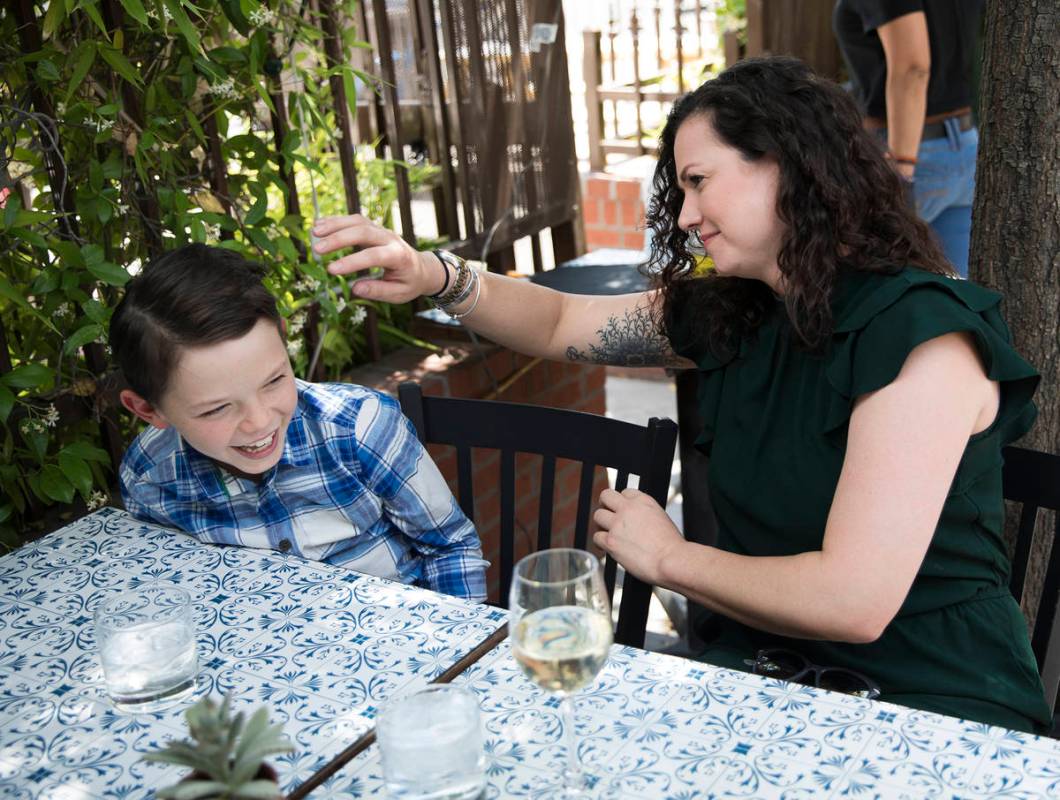 Nicole Silverman fixes the hair of her son Berkeley Brady, 8, while at brunch at 7th & Cars ...