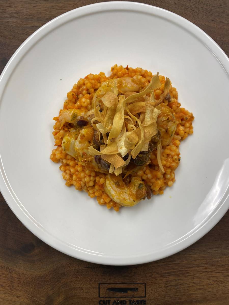 Pan-seared shrimp with Israeli couscous and yellow tomato puttanesca. (Cut and Taste)