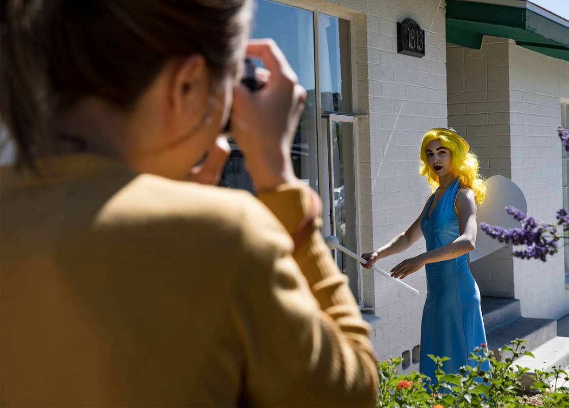 Holly Rae Vaughn takes a photo of Victoria Hogan, dressed as the Blue Angel statue from the fo ...