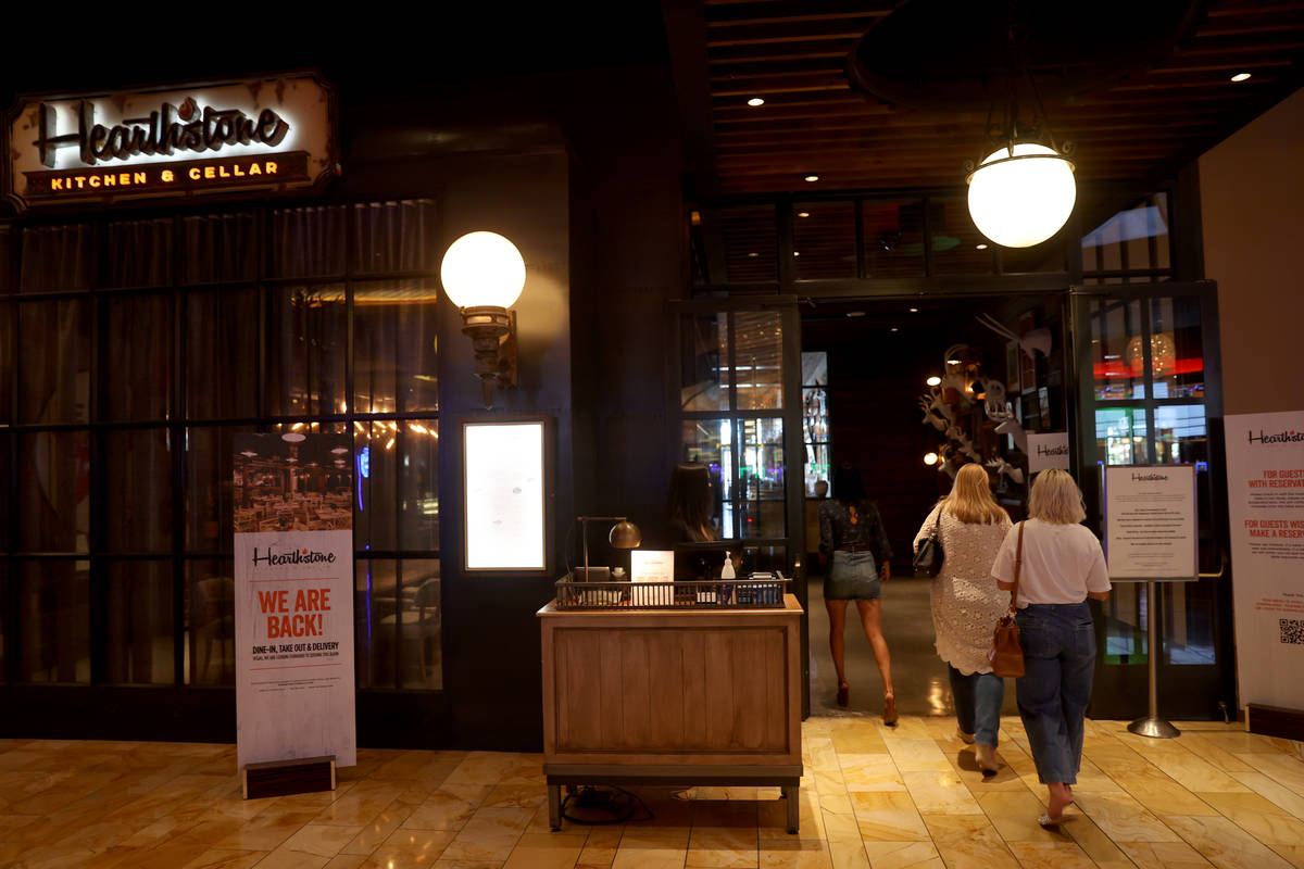 A hostess takes customers to their table at Hearthstone Kitchen & Cellar at Red Rock Resort in ...