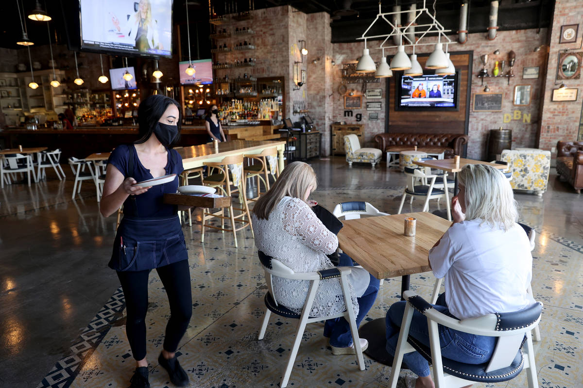 A server sets a customers' table at Hearthstone Kitchen & Cellar at Red Rock Resort in Las Vega ...