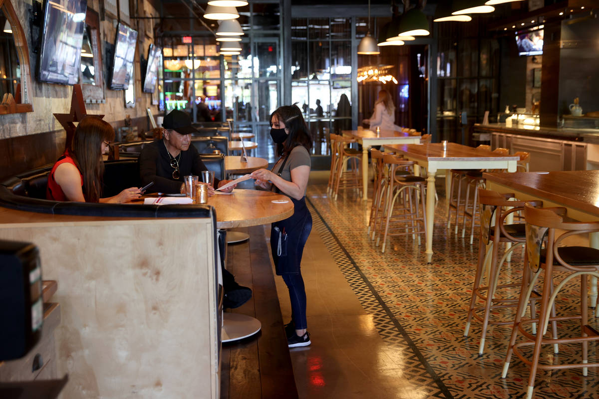 A server helps customers at Hearthstone Kitchen & Cellar at Red Rock Resort in Las Vegas Tuesda ...
