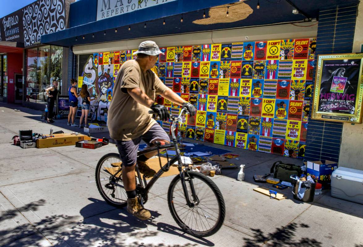A passerby checks things out as the experiential company Good All Day Collective installs about ...