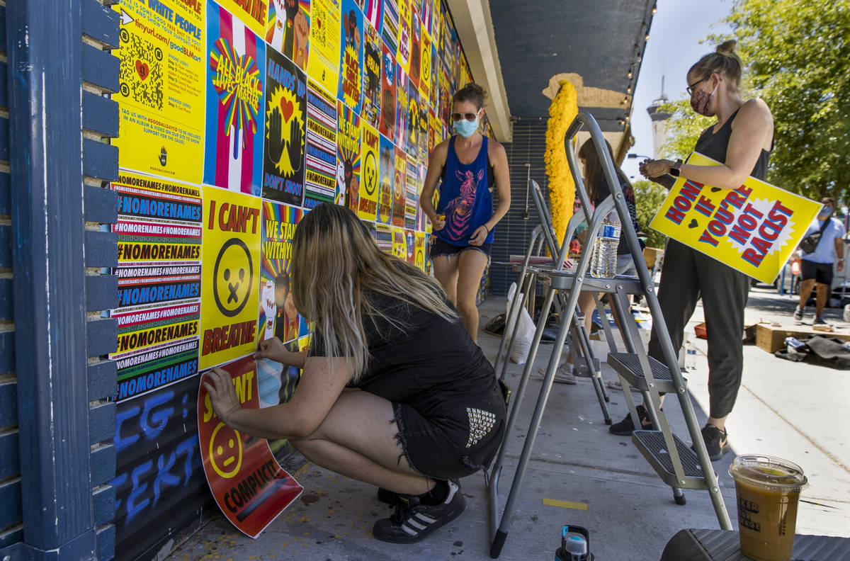 Karen Barraza, left, Cynthia Hartness, Alexis Carbajal and Amy von Rosen attach the last of abo ...