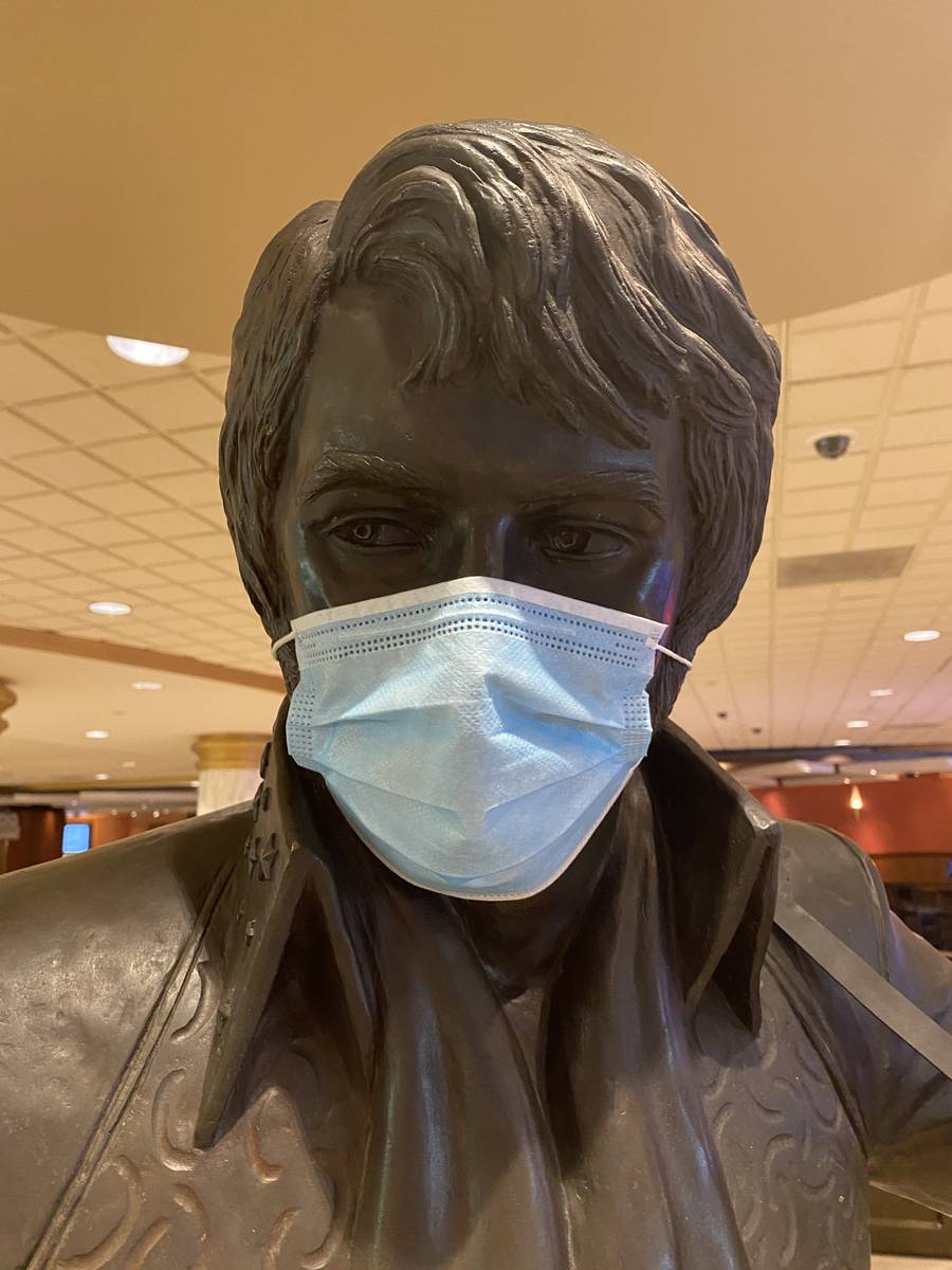 A masked statue of Elvis Presley is shown at Westgate Las Vegas on Thursday, June 18, 2020. (Jo ...