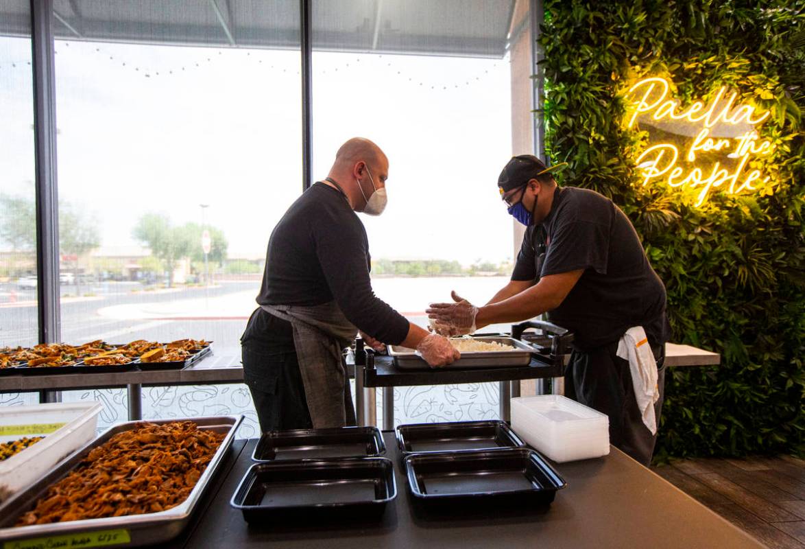 Jeffrey Weiss, left, and Paras Shah, co-owners and co-chefs at Valencian Gold, package meals fo ...
