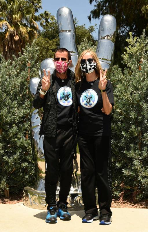 Musician Ringo Starr and his wife Barbara Bach pose together in front of his "Peace and Lo ...