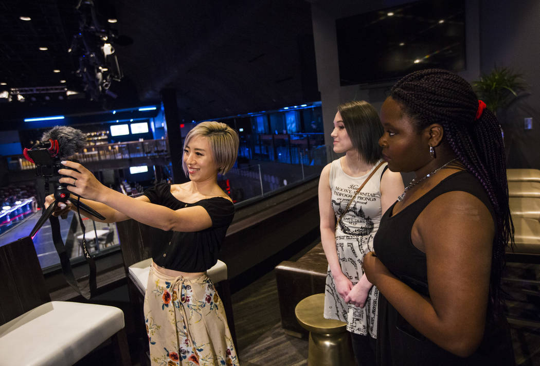 Cosplayer and influencer Stella Chuu, left, records video with grant recipients Giselle Colon, ...