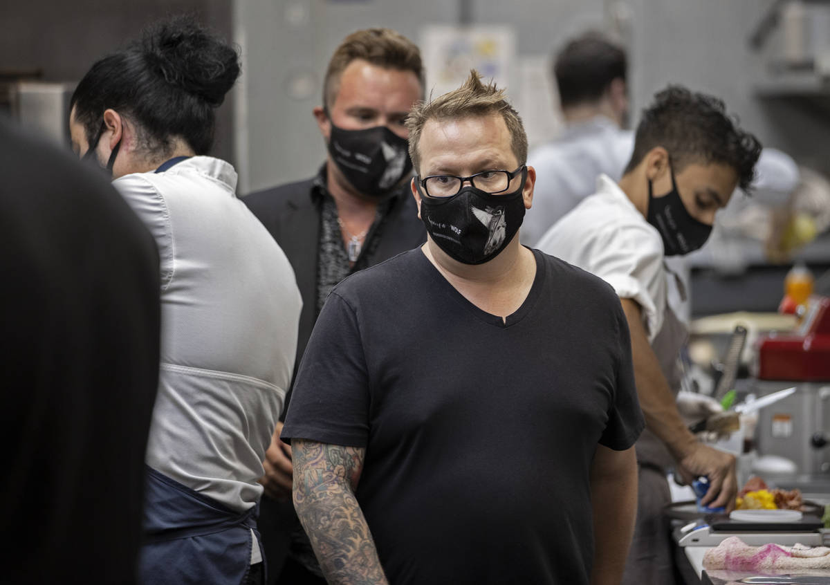 Chef/owner Brian Howard, middle, works in the kitchen wearing a custom face mask at Sparrow + W ...