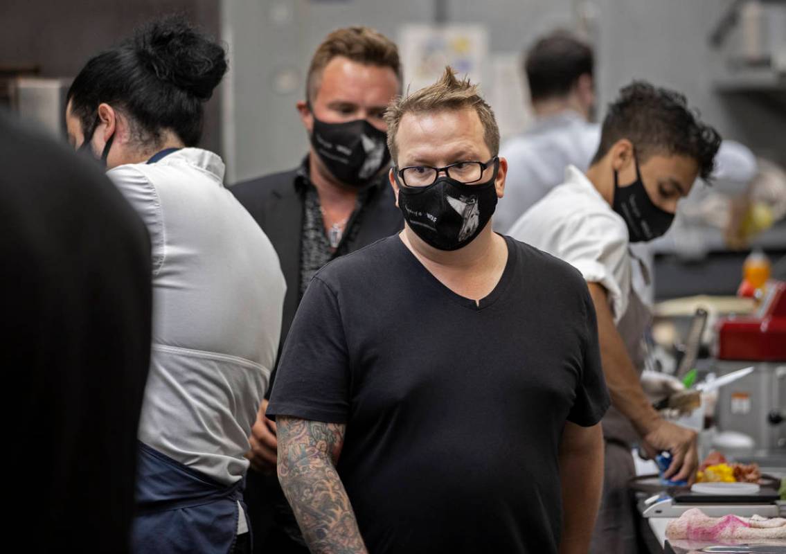 Chef/owner Brian Howard, middle, works in the kitchen wearing a custom face mask at Sparrow + W ...
