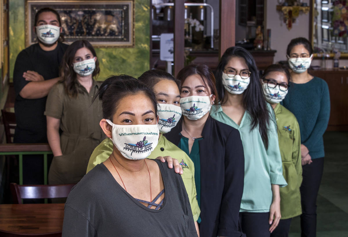 Penny Chutima, left, and sister Sabrina, behind her, joined by other staff members at Lotus of ...