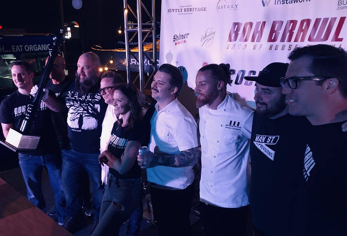 Sean Griffin and Ralph Perrazzo (left) hoist their championship trophy, surrounded by other che ...