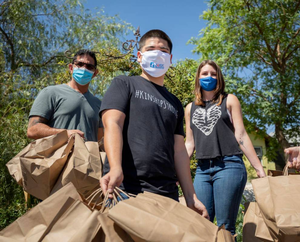 Chef Luke Palladino, left, Foster Kinship operations manager Gustavo Mota, center, and Please S ...