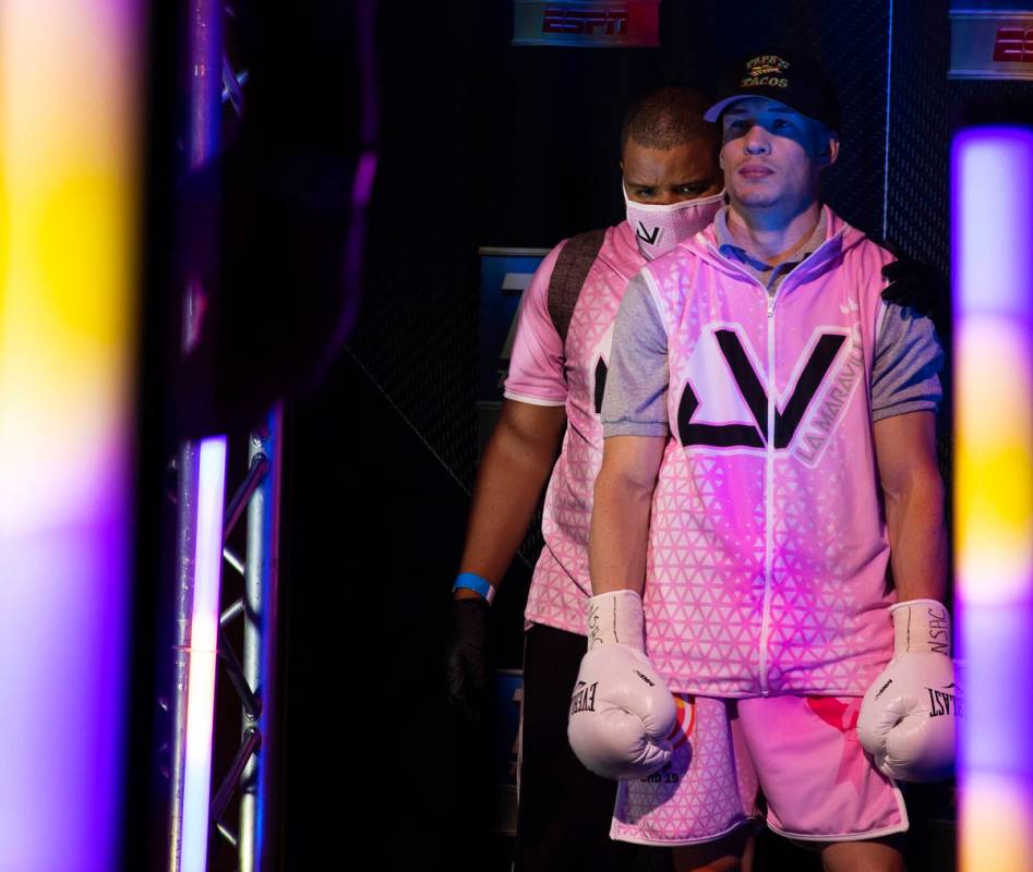 Jayson Velez, right, gets some last minute advice from his trainer while waiting to be announce ...