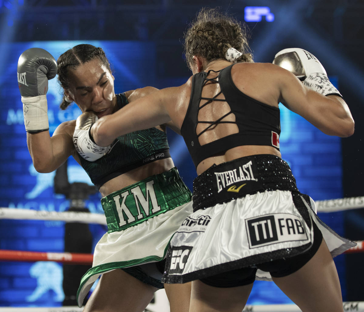 Kim Clavel, right, hands a left hook against Natalie Gonzalez during their light flyweight figh ...