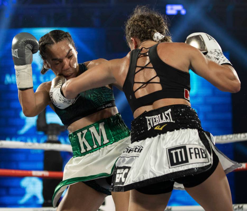 Kim Clavel, right, hands a left hook against Natalie Gonzalez during their light flyweight figh ...
