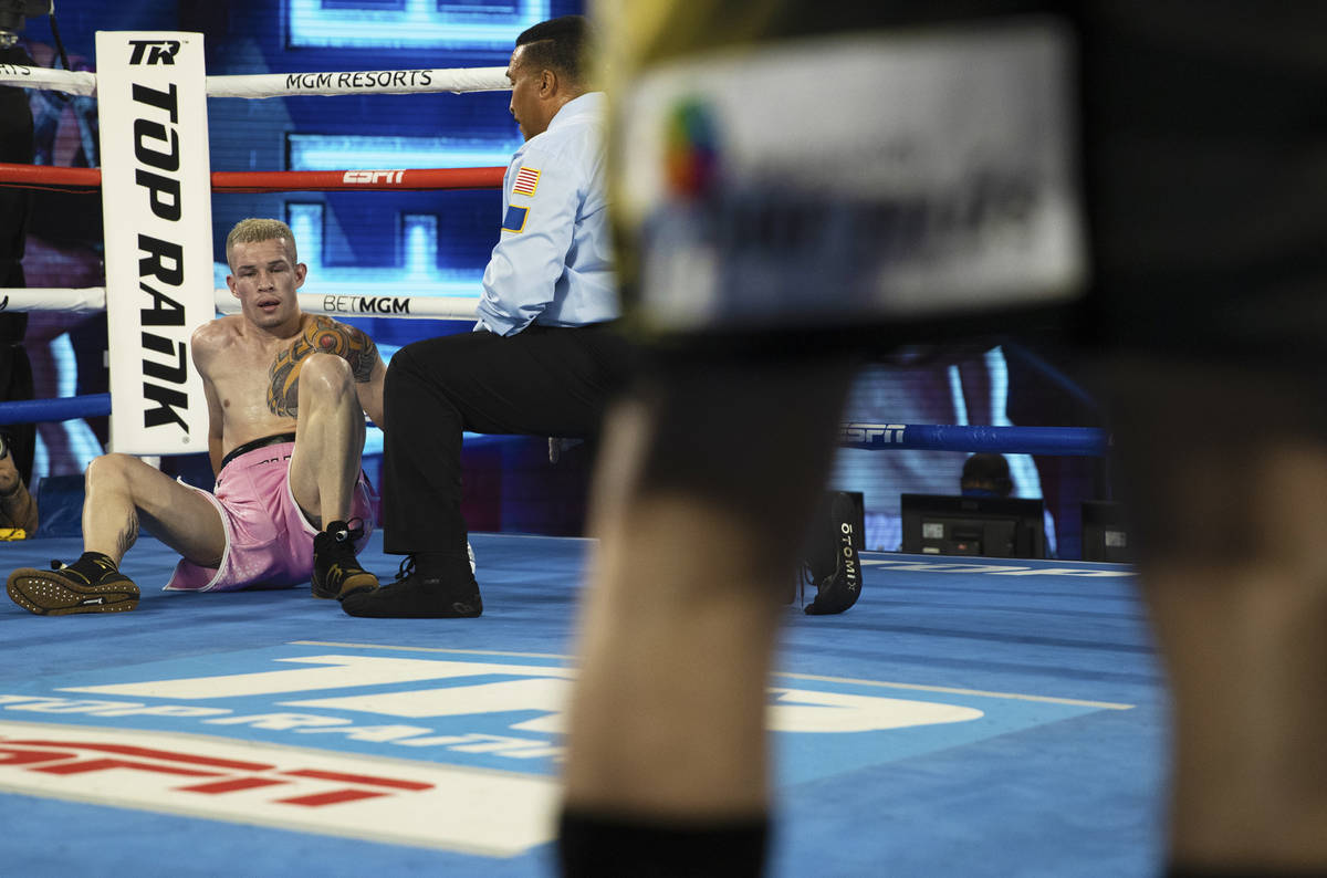 Jayson Velez, back/left, tries to recover after being knocked down by Oscar Valdez during their ...