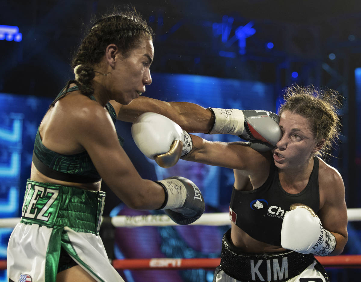 Natalie Gonzalez, left, lands a left hook against Kim Clavel during their light flyweight fight ...