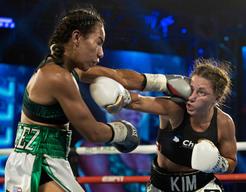 Natalie Gonzalez, left, lands a left hook against Kim Clavel during their light flyweight fight ...