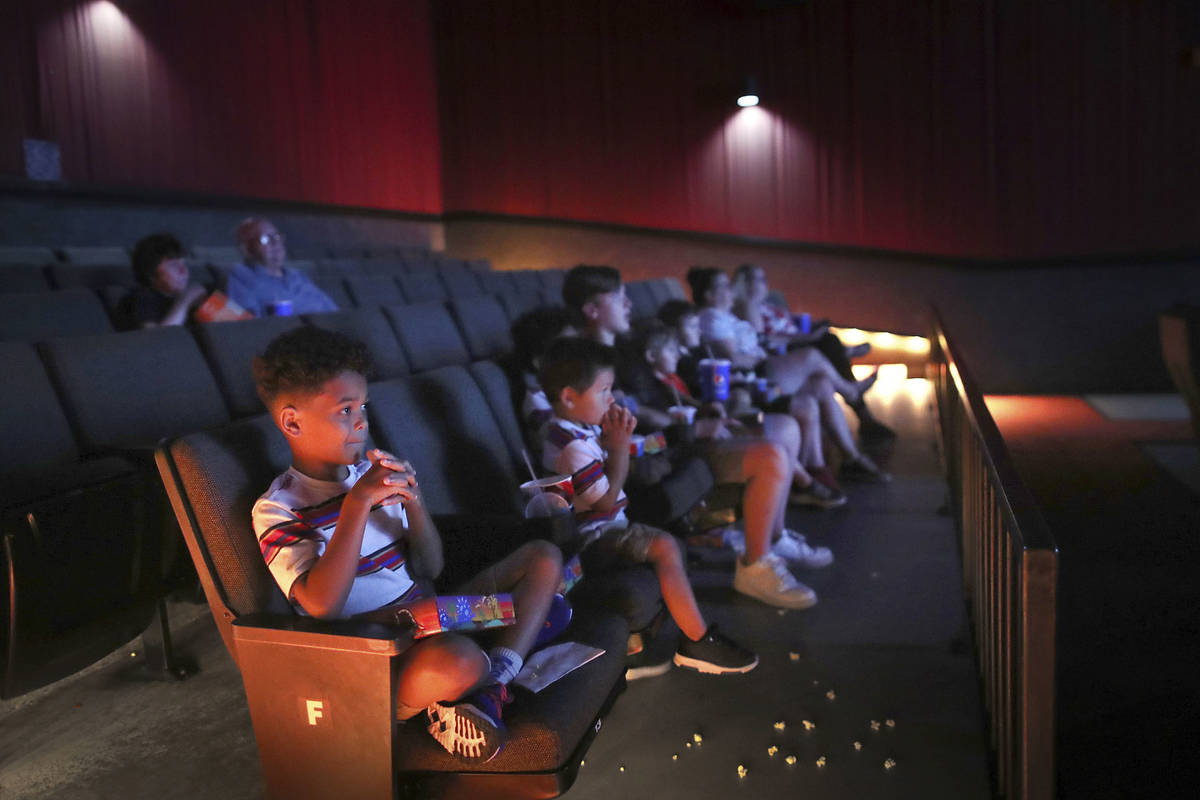 In this July 8, 2020, file photo, Zekhi Fowler sits with cousins as they watch 'Despicable Me' ...
