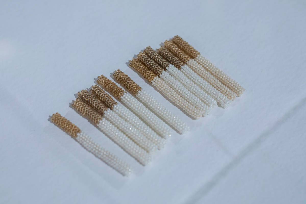 Noelle Garcia's glass beads and thread cigarettes are featured in the exhibit "Excerpts" at UNL ...
