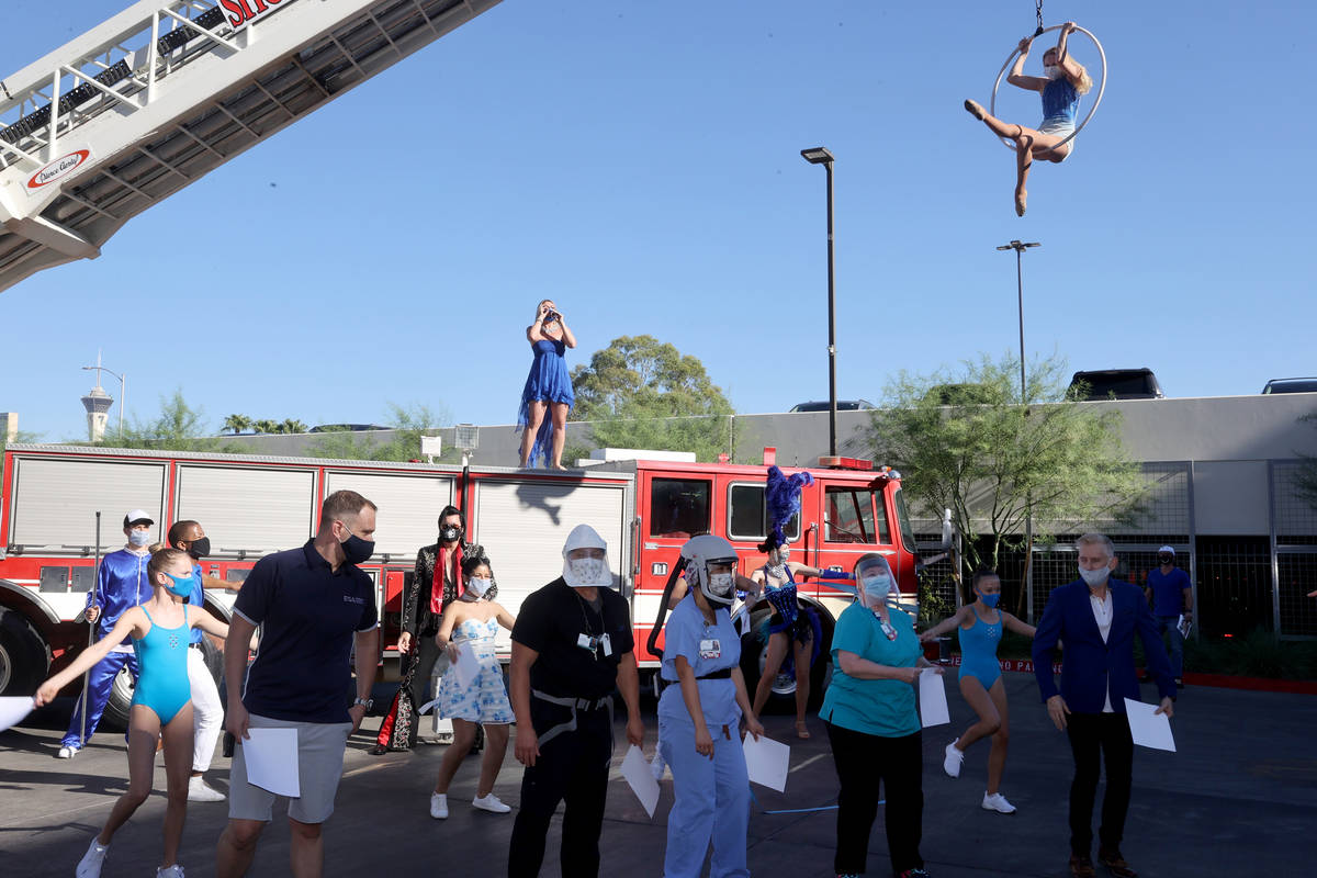 Singer Emily Yates, aerialist Alyssa Gray, other entertainers and medical professionals during ...