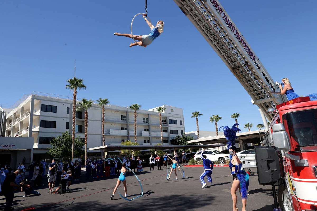Entertainers, including singer Emily Yates and aerialist Alyssa Gray, perform a #MaskUpNV show ...