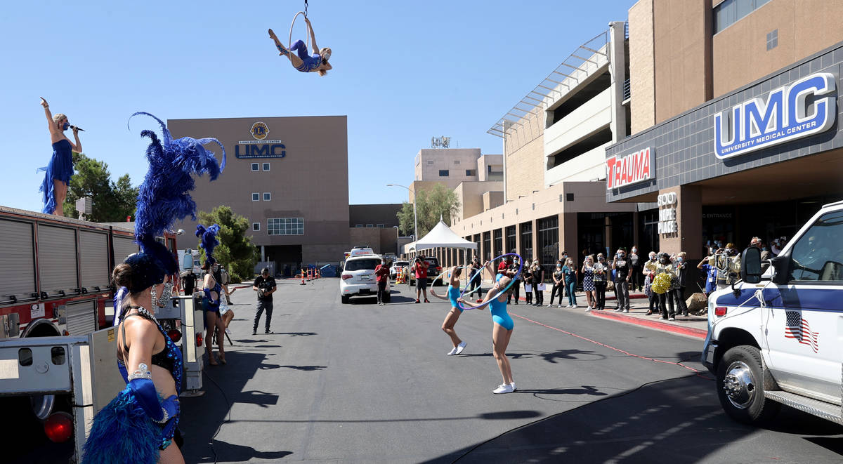 Entertainers, including singer Emily Yates and aerialist Alyssa McCraw perform a show for medic ...