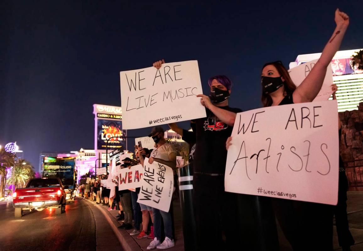 Entertainment workers cheer as cars pass on the Strip during an event to raise awareness about ...