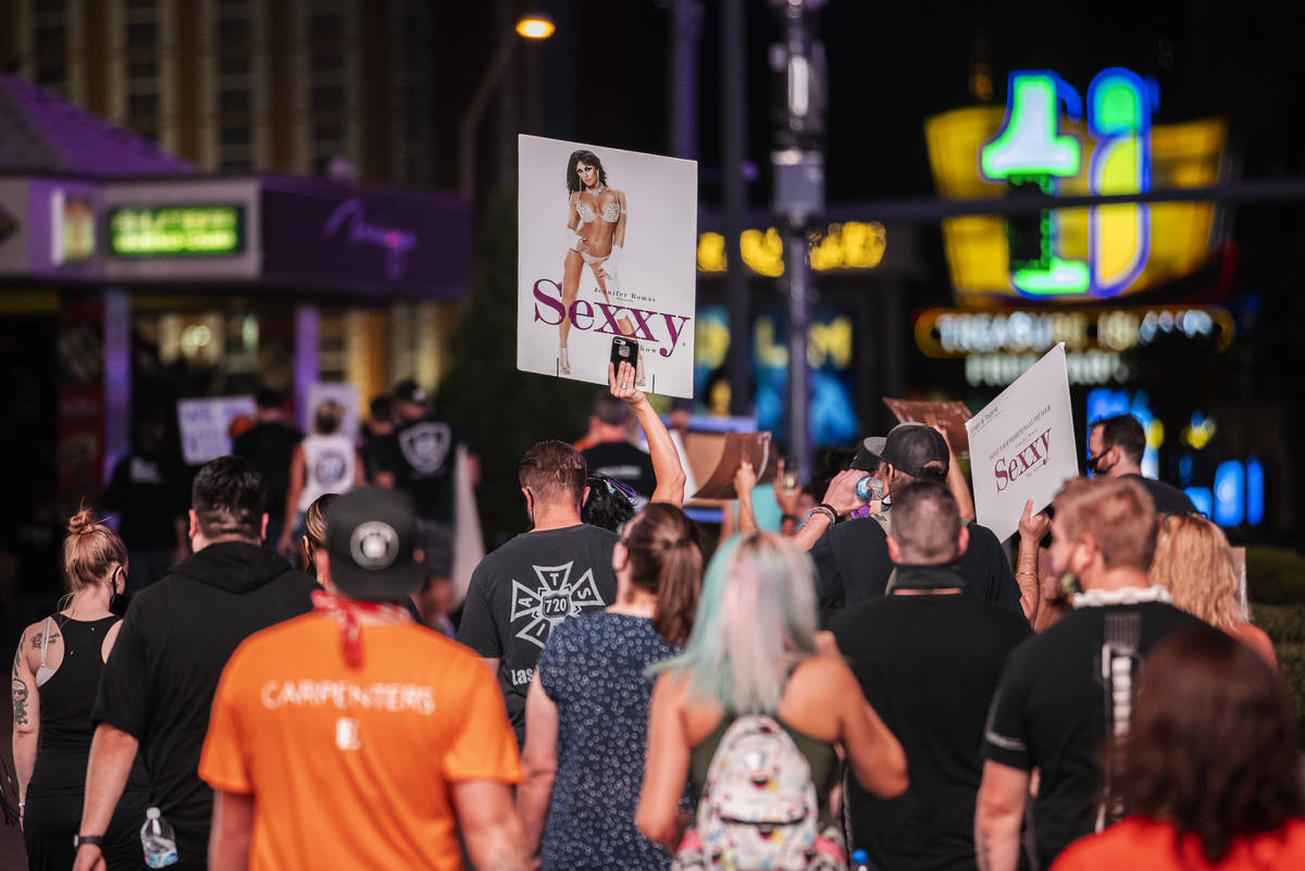 Entertainment workers march south on the Strip during an event to raise awareness about the pli ...