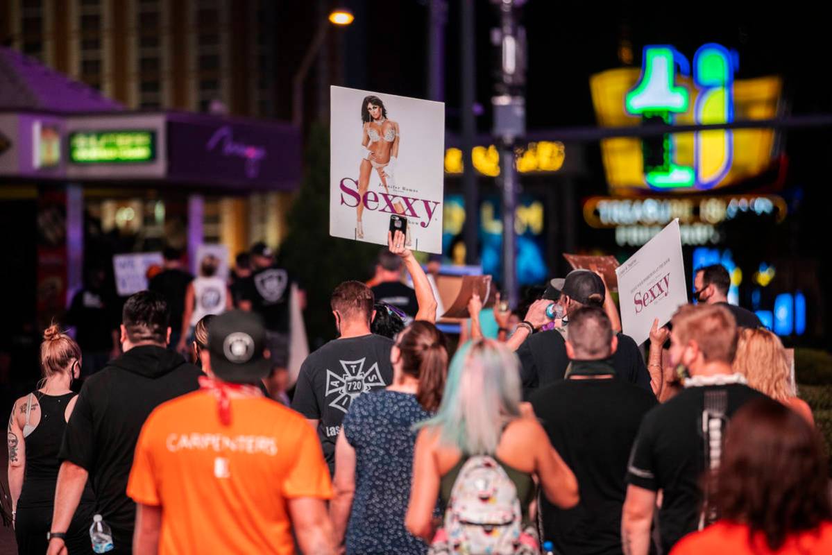Entertainment workers march south on the Strip during an event to raise awareness about the pli ...