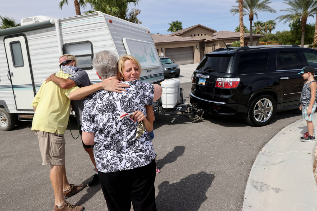 Joe Trammel, left, hugs Don Cleveland as Jessica Trammel hugs Leslie Zak Sunday, Aug. 16, 2020. ...