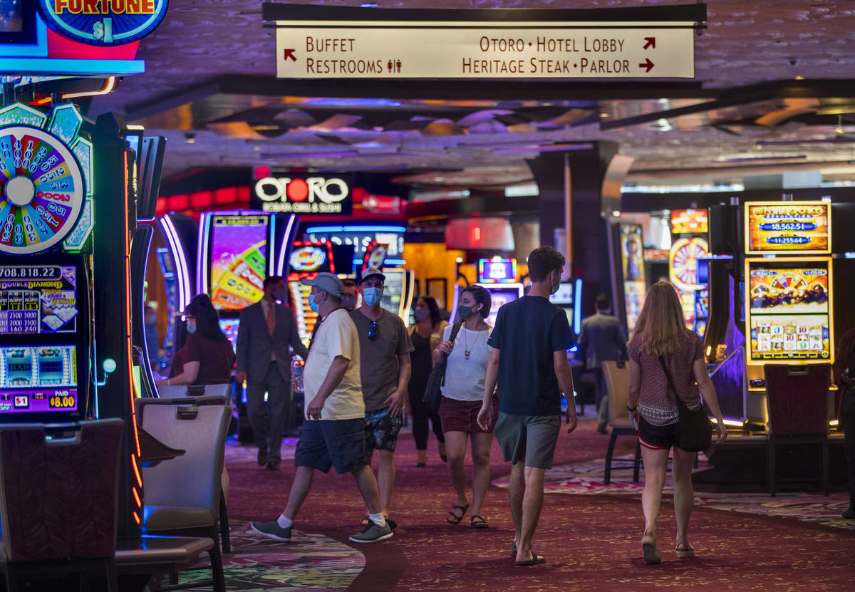 Guests wander about a main walkway in the casino as the Mirage reopens following a COVID-19 shu ...