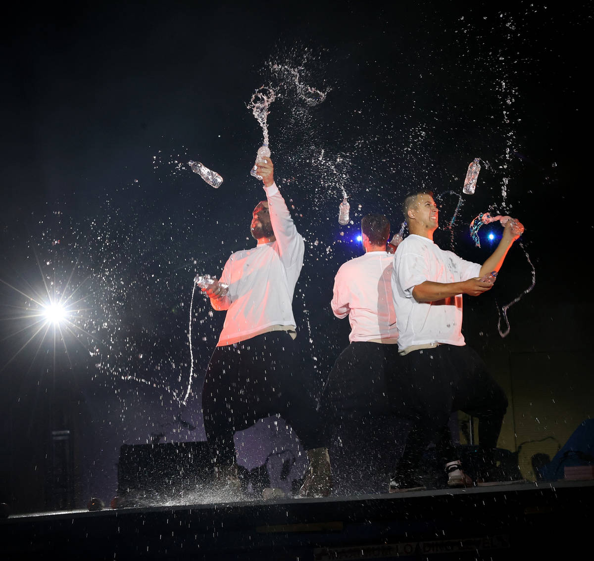 Tony Pezzo, from left, Noah Schmeissner and Doug Sayers juggle open water bottles at Salvage Ci ...