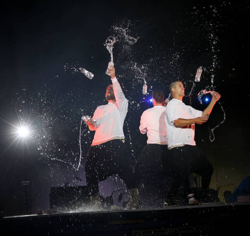 Tony Pezzo, from left, Noah Schmeissner and Doug Sayers juggle open water bottles at Salvage Ci ...