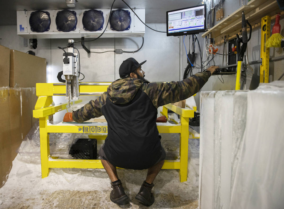 Marco Villarreal, known as "Vegas Ice Man," cuts a fresh block of ice before beginnin ...